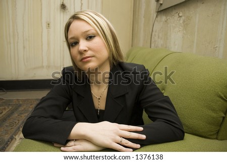 Blonde business woman in grungy old apartment.