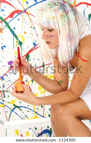 Beautiful woman in white wig and white dress covered in paint.