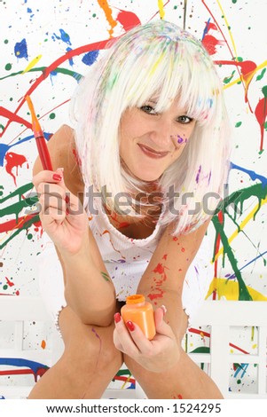 Beautiful woman in white wig, white dress, covered in paint.