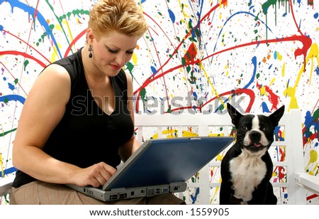 Woman with laptop and dog against painted background.