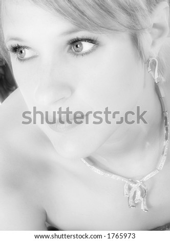 Close up of beautiful 30 year old woman in formal dress. Focus on eyes and lips.  Black and white.