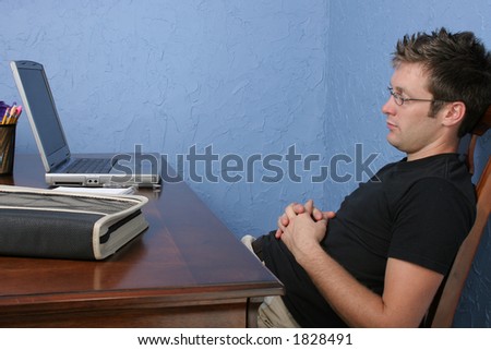 Attractive 25 year old man asleep at desk.