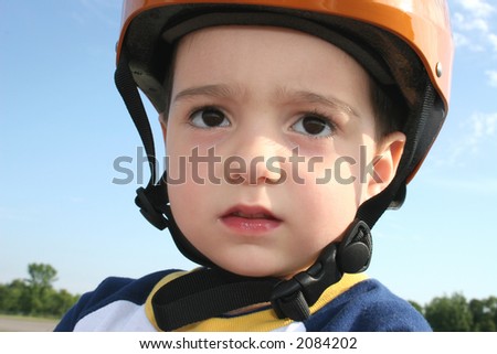 Three year old boy in bicycle helmet.