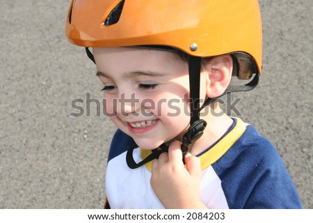 Three year old boy in bicycle helmet.