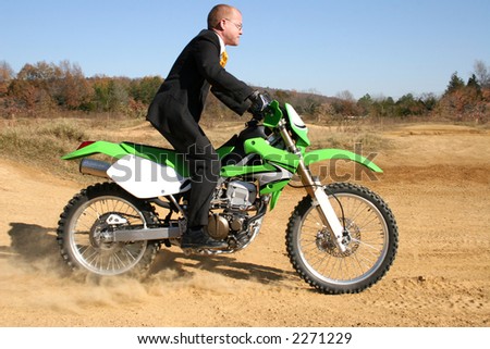stock-photo-thrity-something-business-man-in-suit-riding-dirt-bike-on-dirt-riding-track-2271229.jpg