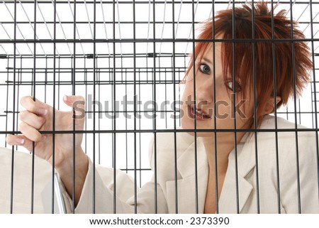 Thirty something business woman trapped in cage.