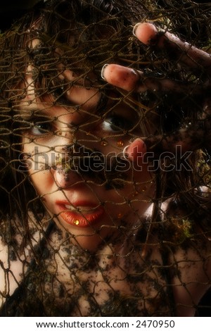 Woman caught in fishnet.  Covered in mud and moss.
