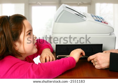Child commerce shopping paying at cash register till in store.