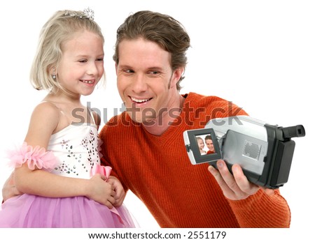 Father and daughter making home videos.  Daughter in ballerina outfit.