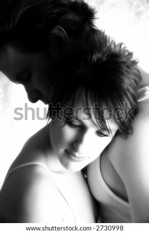 Attractive thirty something couple in embrace.
