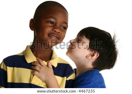Adorable 5 year old black African American boy against white background listening to friend tell secrets.