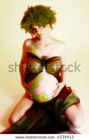 Artistic maternity portrait of a beautiful young woman due in the fall.