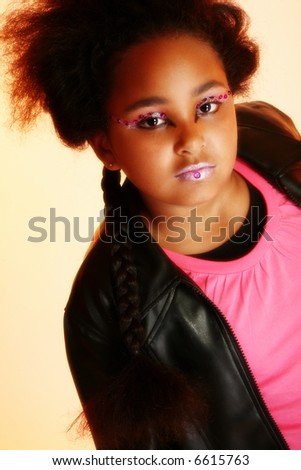 Beautiful ten year old African American girl with artistic cosmetics.