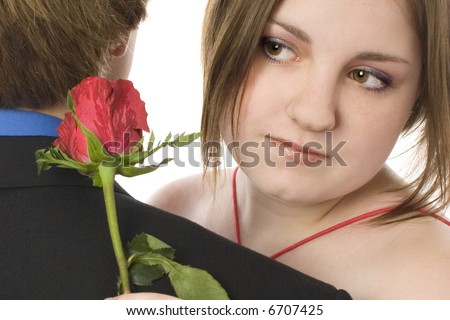 stock photo Adorable teen couple in formals with roses