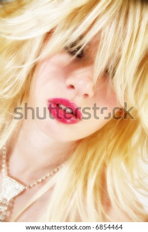 Beautiful blonde Hispanic American woman with gorgeous lips and shaggy blonde hair.