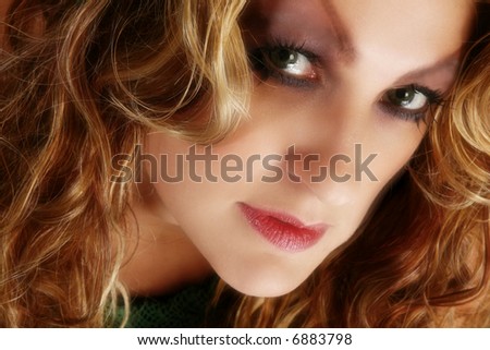 Beautiful 30 year old woman with long curly hair and artistic make-up.