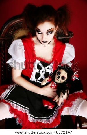 stock photo Woman dressed as anime style goth doll with matching toy doll