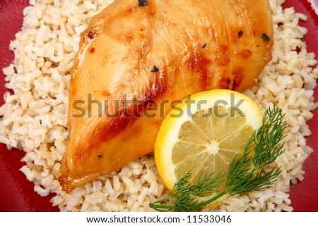Lemonade Chicken and brown rice with lemon slice and dill.
