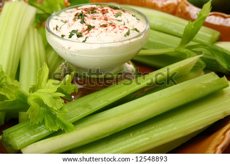 Sliced celery spears on plate with Paprika Ranch Dressing.