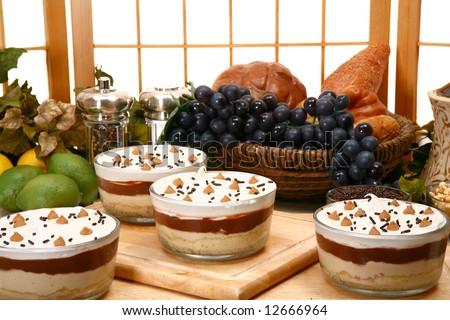 Layered peanut butter pudding with peanut butter mouse, chocolate pudding, vanilla pudding, whipped topping on a pie crust.