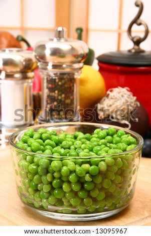 Bowl of fresh green peas in kitchen or restaurant.