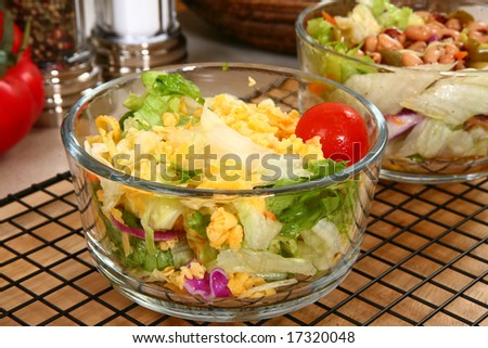 Dinner garden salad in glass bowl in kitchen or restaurant.