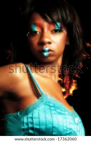 Beautiful African American woman in artistic cosmetics.