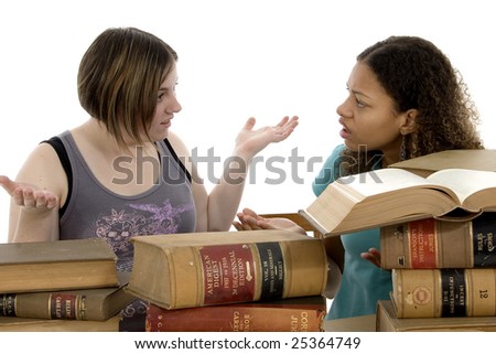 Copyright on books has expired....  Study Session. Teen girls at table with old law books.