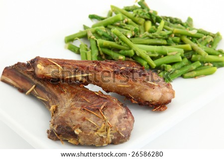 Grilled Ginger Lamb Chops and Steamed Asparagus over white.