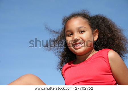 Adorable five year old African American Girl outside at park.