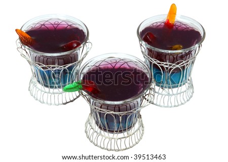 Blue berry gelitan and grape gelatin with gummy worms and spiders over white with clipping path.