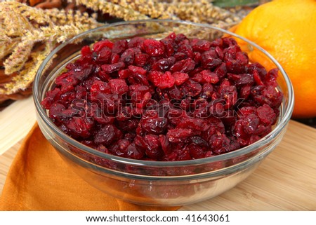 Glass bowl of dried cranberries or craisins in kitchen.