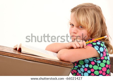 Adorable 7 Year Old Girl Making Angry Expression In Desk Over