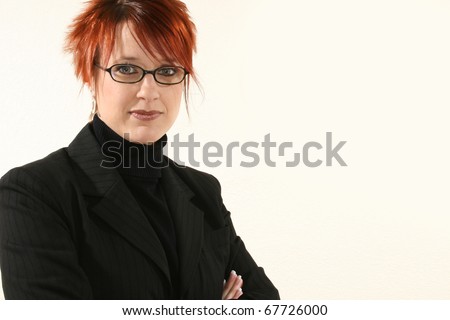 Beautiful 30 year old business woman in black suit with kind  expression.  With Glasses.