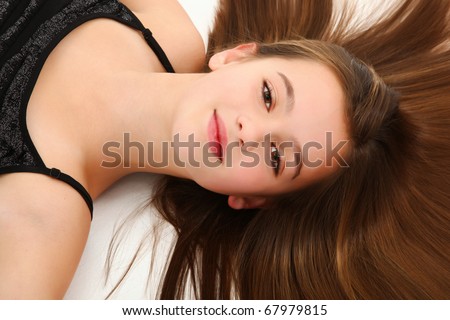 Beautiful 10 year old tween girl laying on floor with hair fanned out.