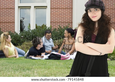 Attractive 20 year old college student on campus.  Group of students in study group behind her.