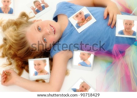 Beautiful young girl child in dance tutu laying on floor after playing with instant camera.