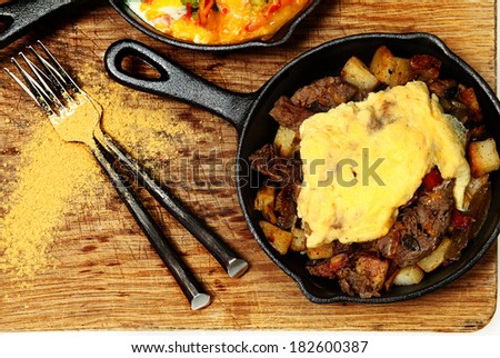 Texas Skillet Breakfast with Steak, Potato and Egg on Table
