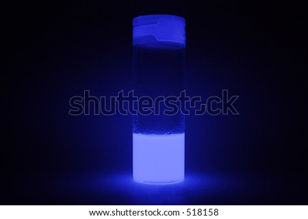 A stoppered glass sample bottle containing a blue cyalume type glow in the dark liquid. 30 second exposure.