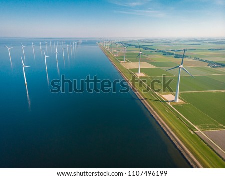 Windmill park offshore and onshore in the Netherlands, huge windmill farm at the Noordoostpolder Flevoland
