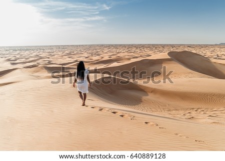 Woman my wife with white dress walking in the dubai desert sand dunes with footsteps in the dubai desert sand, Dubai Emirates, woman in the desert, foot steps in the desert, Dubai escape,woman dress