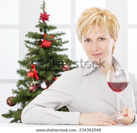 Forty years old lady  with glass of wine on christmas