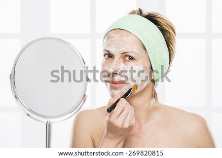 Forty years old woman\
putting mask on face