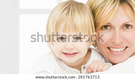 Forty years old mother\
with her two years old baby girl
