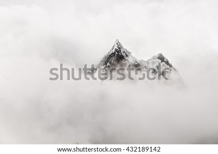 Mountain top surrounded by clouds