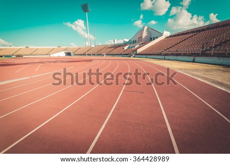 Red running track in stadium. Running track on blue sky. field run in stadium background.