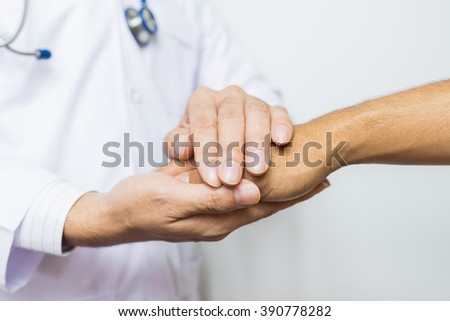 Two people holding hands for comfort
