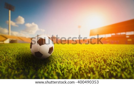 Soccer ball on grass in soccer stadium. soccer football. soccer sport world class. soccer ball on field concept. Soccer ball on vivid tone. soccer ball in soccer stadium on sunset. soccer field.