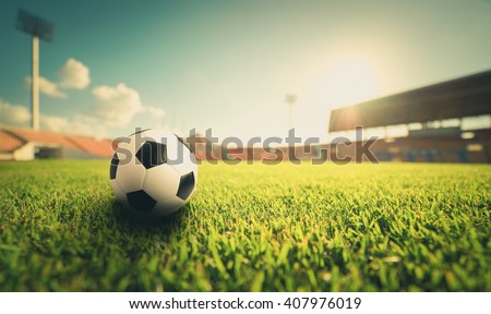 Soccer ball on the grass in soccer stadium , vintage tone