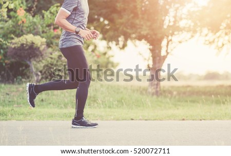 Young man is running on road sunset. Fitness man running at city park. Male strong athlete exercising outdoor. vintage tone.